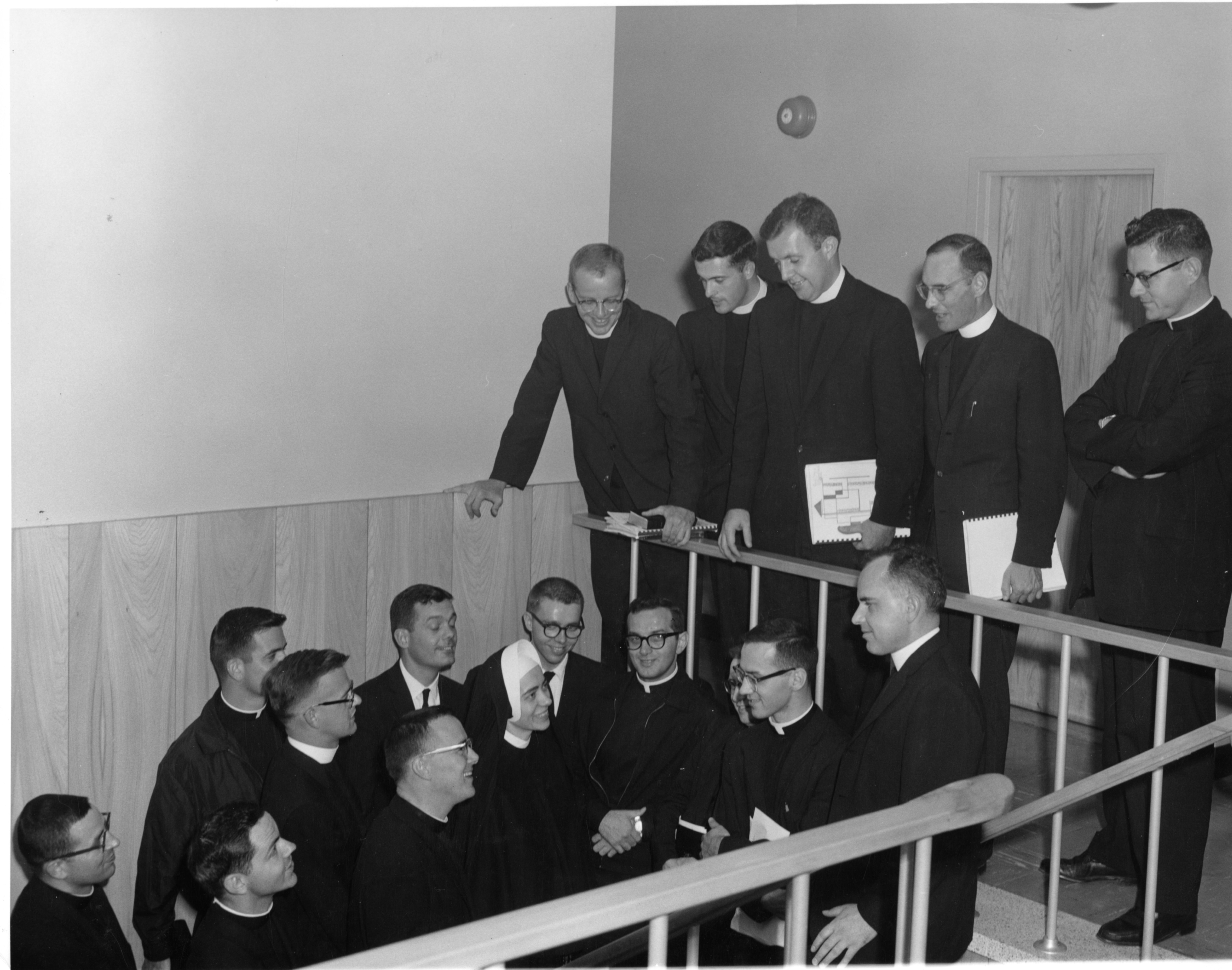 Carol Frances jegen BVM in habit surrounded by males at a religious education workshop
